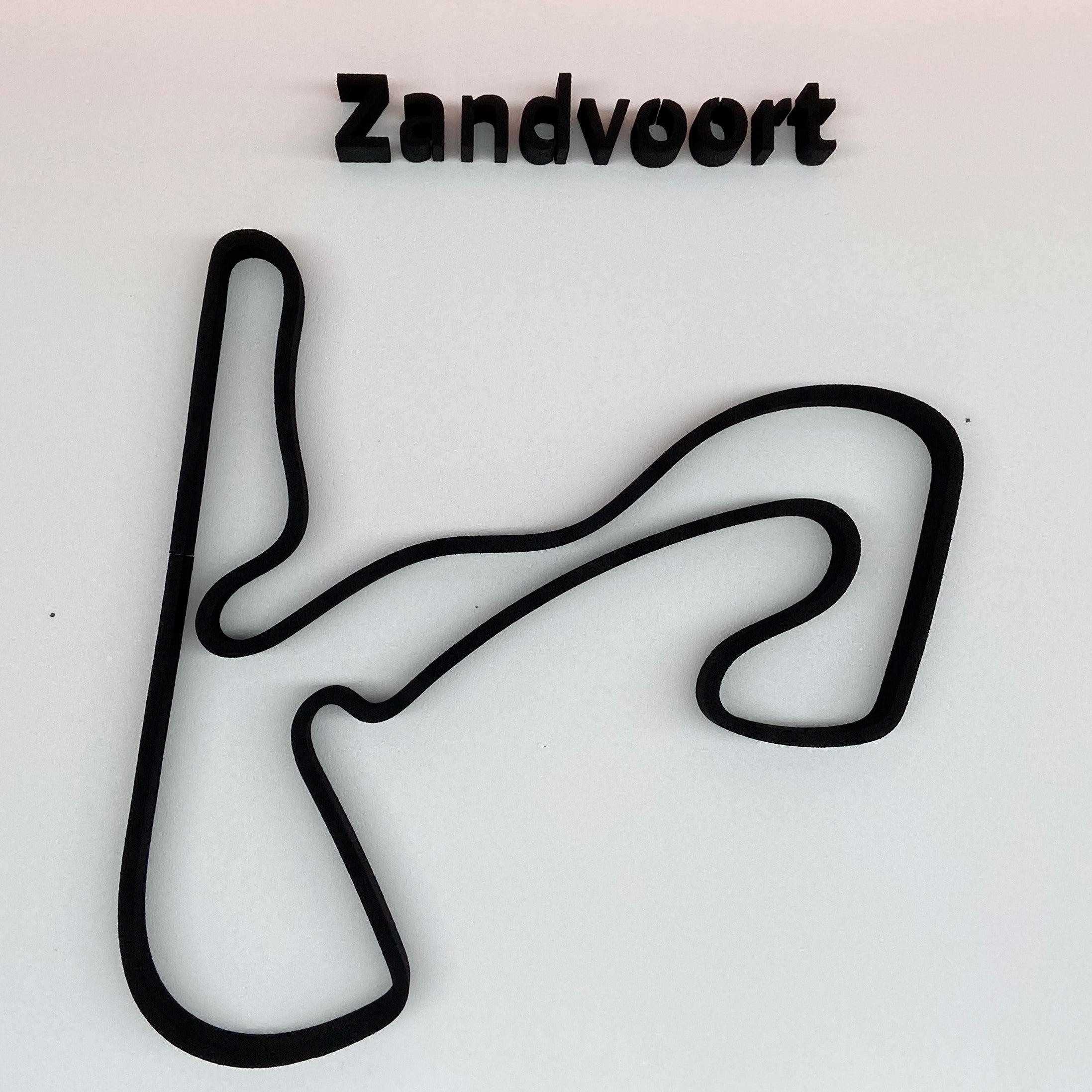Black race track layout with 'Zandvoort' text on a light gray background